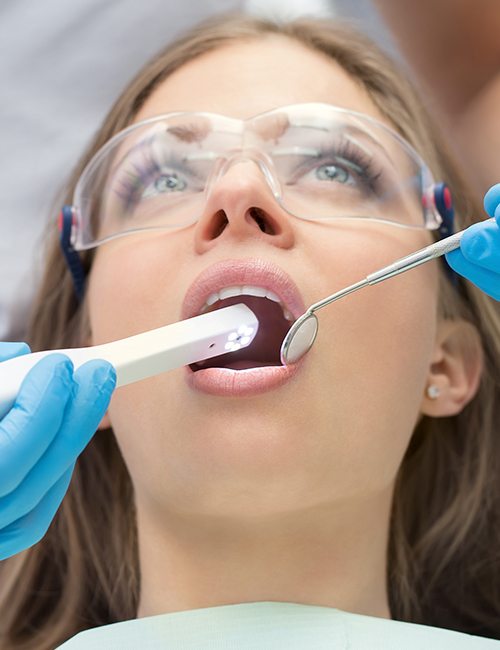 Dentist using intraoral camera to capture images of patient's smile