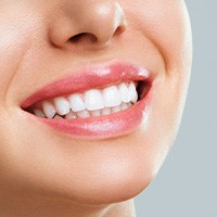 Nose-to-neck closeup of woman smiling