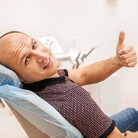 man smiling after getting dental implants in Temple