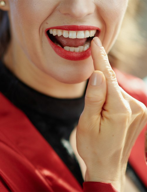 A patient smiling and inspecting their teeth following cosmetic bonding