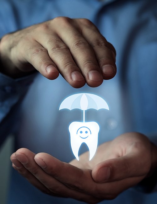 Hand holding animated tooth under an umbrella