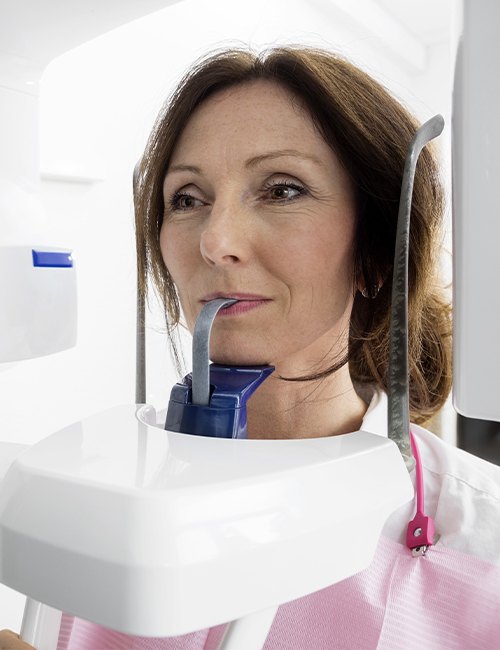 Woman receiving 3 D C T cone beam x-ray scans