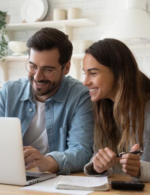Man and woman looking for an in-network dentist on their laptop 