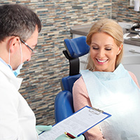 patient smiling while visiting dentist