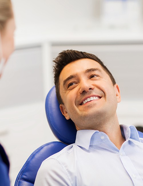 Man smiles at dentist