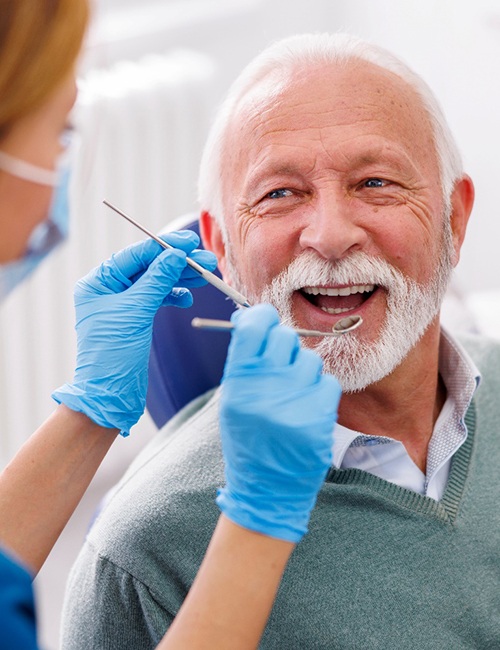 Man smiles at dentist