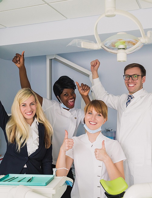 Dental team members smiling and cheering