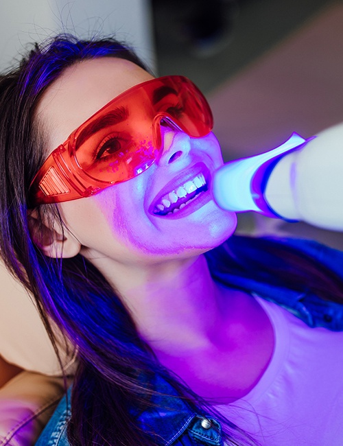 Woman receiving teeth whitening treatment