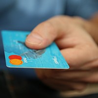Man extending credit card for payment