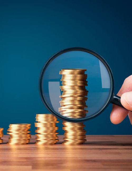 Stacks of coins examined with magnifying glass