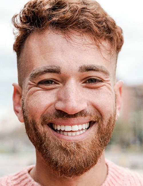 man smiling after getting dental crowns in Temple