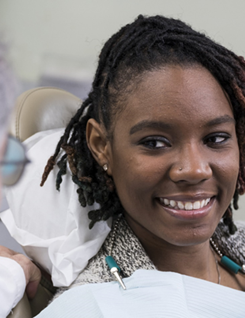 a patient smiling at their dentist