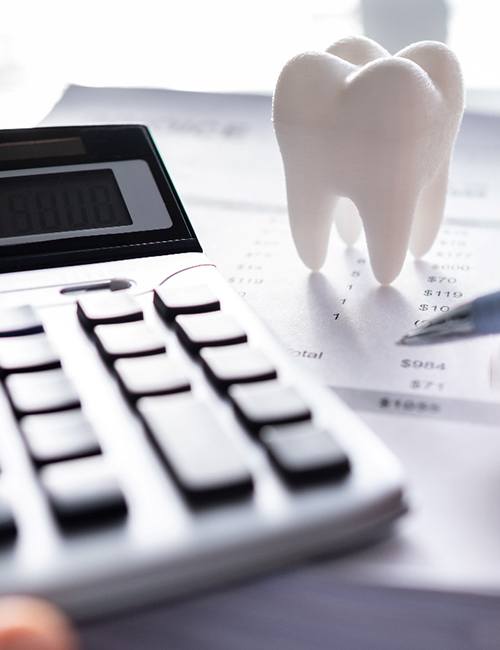 A patient calculating the cost of dentures