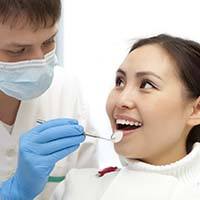 Woman visiting her Temple dentist for dental checkup