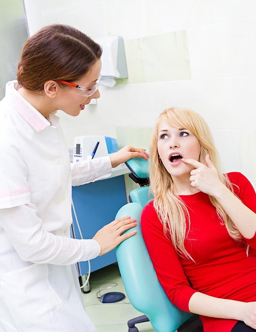 Woman and dentist discussing tooth extractions in Temple 