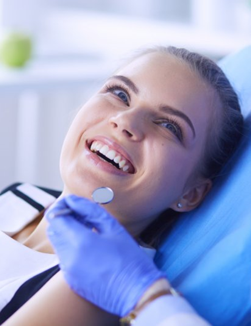 a patient smiling after getting her dental implants in Temple