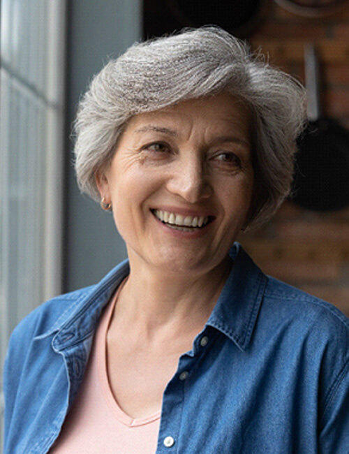 woman smiling by a window