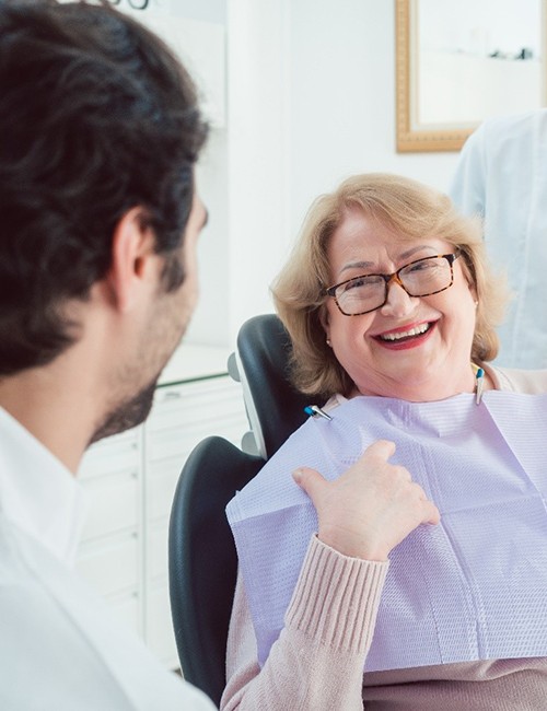 Patient smiling at implant dentist in Temple