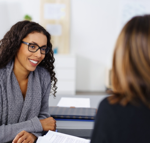 Woman discussing dental insurance with team member