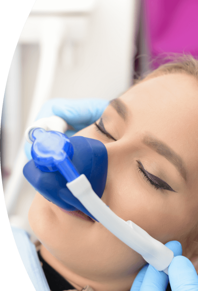 Relaxed patient with nitrous oxide sedation dentistry mask in place