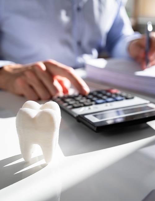 Person calculating dental insurance coverage