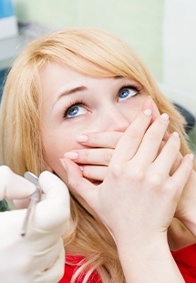 woman scared of dentist covering her mouth in Belton
