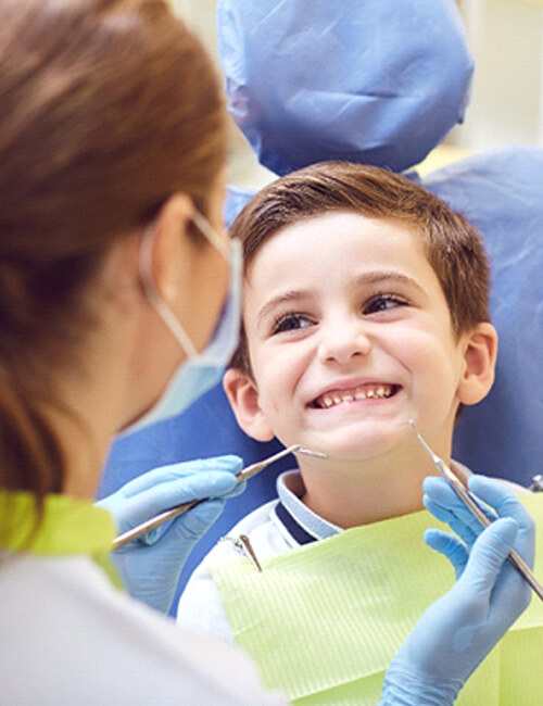 A little boy having his teeth examined during a regular visit