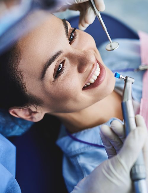 Patient receiving preventive dentistry checkup and teeth cleaning