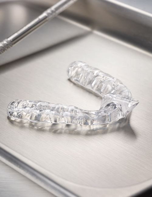 Clear nightguard for bruxism on metal tray