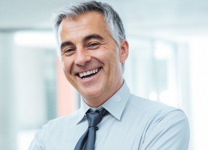 Man with healthy smile after gum disease treatment