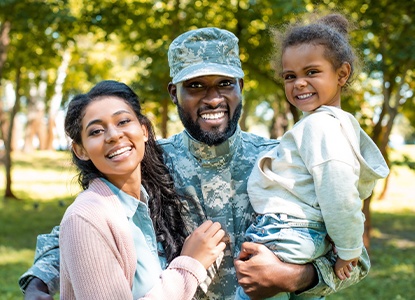 Family of three smiling together after wisdom tooth extraction visit