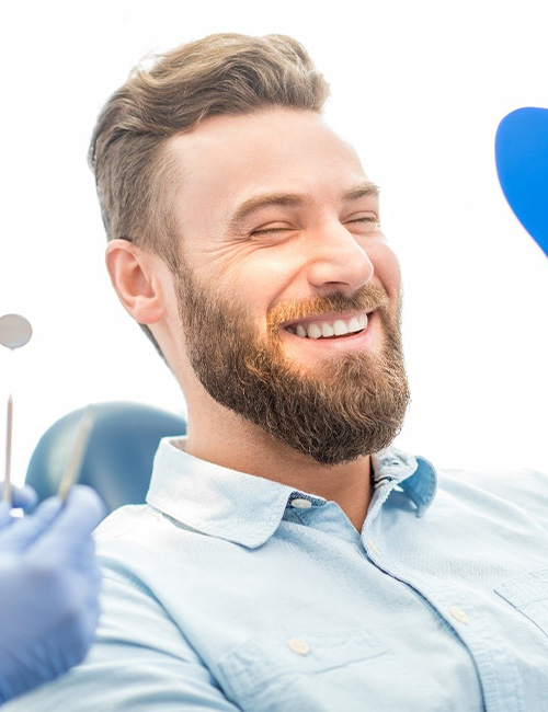 Man smiling while getting veneers in Temple