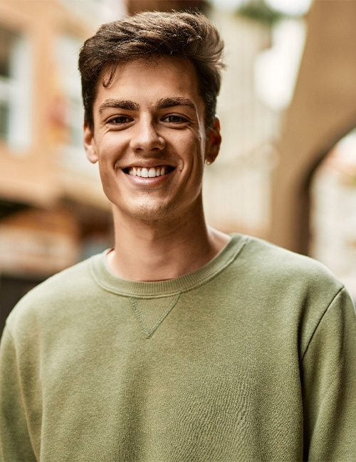 smiling after getting veneers in temple