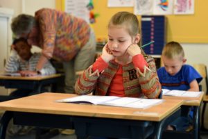 Young girl at school after seeing children’s dentist