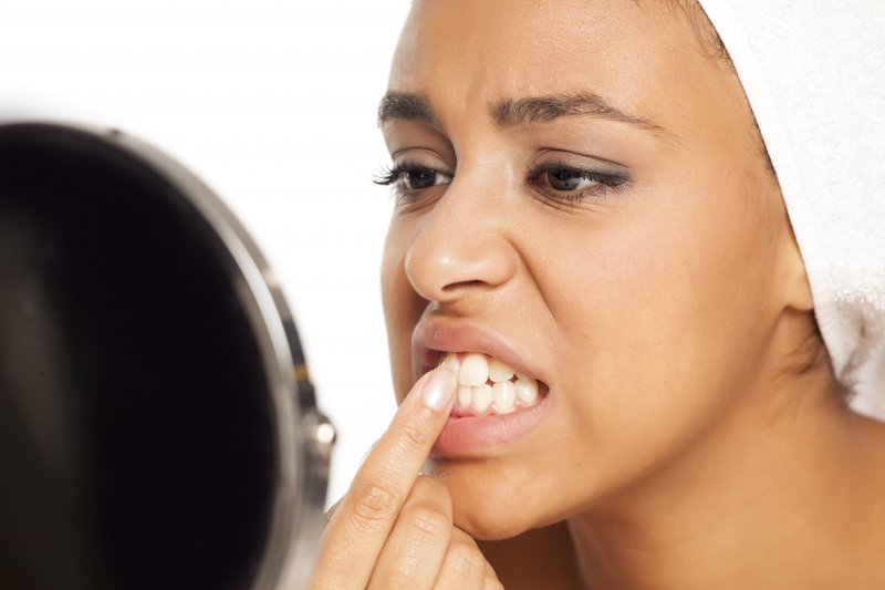 young woman picking her teeth 