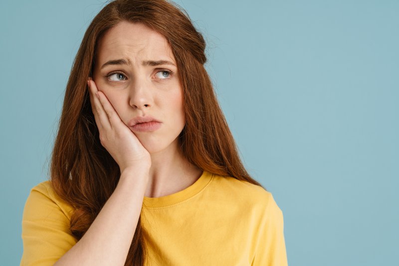 young woman with painful toothache