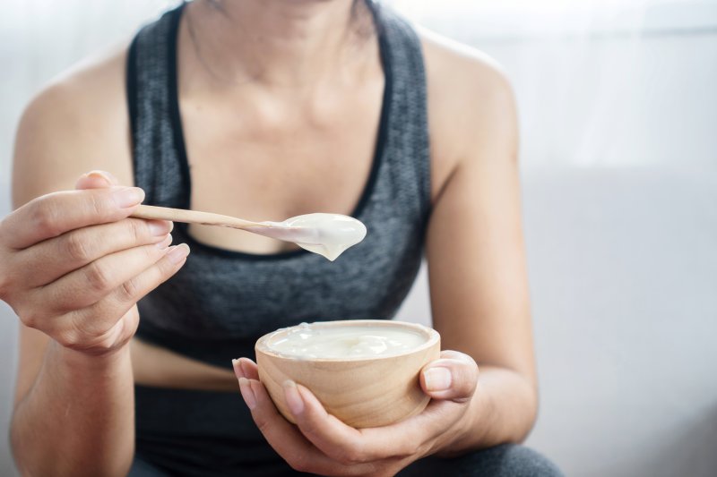 person eating yogurt after wisdom tooth extractions in Temple