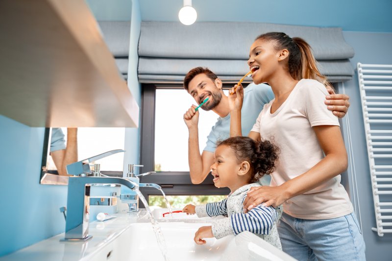 A family brushing their teeth together