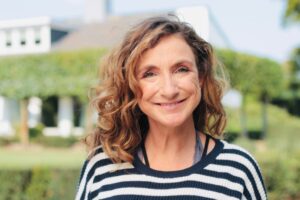 smiling middle-aged woman standing outside