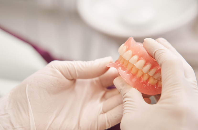 Dentist holding dentures