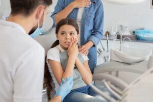 Child at the dentist with a toothache
